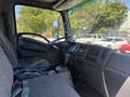 Interior of a 2022 Isuzu NQR showcasing the driver's seat dashboard and steering wheel with a gray fabric upholstery