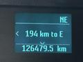 A digital display showing navigation information with a distance of 194 km to empty and a total distance of 126479.5 km on a 2015 Ford F-150