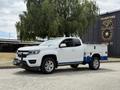 A 2017 Chevrolet Colorado pickup truck in white with blue accents and a utility bed featuring tool storage compartments