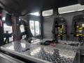 Interior of a 2006 E-One Typhoon featuring a metal storage area and multiple seats equipped with safety harnesses