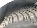 Close-up view of a tire with a deep tread pattern showcasing wear on a 2017 Ford Transit Connect