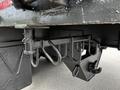 Close-up of the rear hitch assembly of a 2011 International 4400 featuring various hooks and mounting points for towing equipment