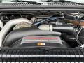 Close-up of a 2006 Ford F-450 SD engine featuring a Power Stroke V8 Turbo Diesel logo with various engine components visible