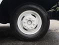 A close-up of a white wheel and tire from a 2018 Ford Econoline showing a five-bolt pattern and a black rubber tire with tread details