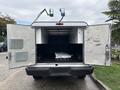 A 2020 Ford F-150 with its rear doors open revealing a spacious cargo area with a metal panel inside