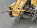 A yellow 2014 Vermeer Corporation Sweep Stump Cutter featuring a metallic cutting wheel with serrated teeth and a sturdy handle attached to the front