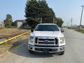 A white 2016 Ford F-150 truck facing forward with a black grille and chrome accents