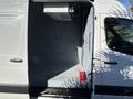 A 2021 Mercedes-Benz Sprinter 2500 with an open side door revealing a spacious, empty cargo area lined with gray insulation material