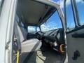 Interior view of a 1997 Freightliner FL70 truck showing the driver seat dashboard and passenger seat