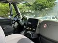 Interior view of a 2011 International 4300 truck featuring a dashboard steering wheel gear shifter and controls