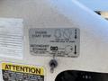 A close-up view of a control panel featuring engine start-stop instructions and a warning about secondary stowage on a 2013 International 7500