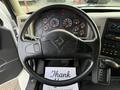 The steering wheel and dashboard of a 2013 International Durastar 4300 featuring a black steering wheel and various gauges and controls
