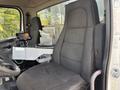 Interior view of a Freightliner 114SD showing a driver's seat and a control panel with various controls and displays