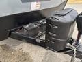 Close-up of the front of a 2021 Jayco Jay Flight travel trailer showing the power connections and a black battery box attached to the hitch