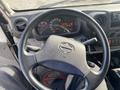 The interior of a 2019 Hino 195 featuring a steering wheel with the Hino logo a dashboard with gauges and controls visible