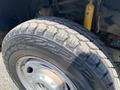 Close-up of a tire from a 2017 Ford F-250 SD showcasing a rugged tread pattern and silver alloy rim