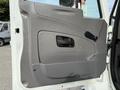 The image shows the gray interior door panel of a 2008 International 4300 with a handle and a window control mechanism