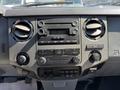 Dashboard of a 2012 Ford F-350 SD featuring air conditioning controls a radio and various buttons for vehicle functions
