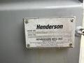 A metal identification plate featuring the name Henderson and details such as model and serial numbers attached to a vehicle