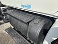 A black cylindrical biodiesel fuel tank attached to a 2006 International 4300 truck with a textured step on top