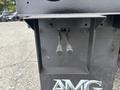 The image shows the rear section of a 2013 Freightliner 114SD featuring a rectangular cutout with two metal levers protruding from it