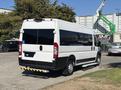 A white 2020 RAM ProMaster 3500 van with tinted windows parked with a step on the side and no visible markings