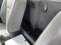 Interior view of a 2016 RAM 5500 showing front seats and a black panel with a storage compartment beneath