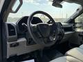 Interior view of a 2022 Ford F-550 featuring a steering wheel and dashboard with various controls and displays