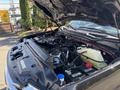 Engine compartment of a 2022 Ford F-350 SD showcasing the engine components and battery with visible hoses and fluid reservoirs