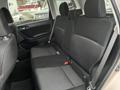 Interior view of the back seat of a 2016 Subaru Forester featuring two rows of seats with dark fabric and seat belts visible