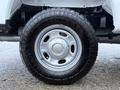 A close-up of the wheel and tire of a 2023 Ford F-250 showcasing a silver rim and a rugged all-terrain tire