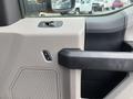 The interior door panel of a 2017 Ford F-250 SD featuring a handle control and window buttons