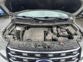 A 2016 Ford Explorer with its hood raised revealing a dirty engine compartment including various engine components and fluid reservoirs