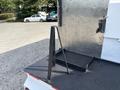 A black metal stand on the rear of a truck bed used for stabilizing or supporting equipment