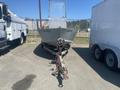 2010 Aluminum 16 foot boat on a trailer facing forward with a visible tongue hitch and a cabin structure at the rear