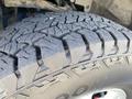 Close-up of a rugged tire with deep treads designed for off-road traction mounted on a 2015 Ford F-150
