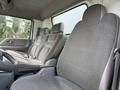 Interior of a 2008 International CityStar showing grey upholstered seats in the front cabin with a steering wheel and dashboard visible