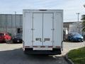 A 2019 Ford Econoline box truck viewed from the rear with double doors and bumper visible