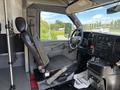 Interior of a 2020 Chevrolet Express showing the driver's seat dashboard and controls with a focus on the steering wheel and gear shift