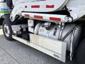 A 2011 Autocar Xpeditor with visible mechanical components including a large gas tank and metal step on the side