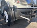 A 2008 International 4400 truck with a black front bumper and a metallic hitch attachment on the driver's side along with a visible tire and wheel