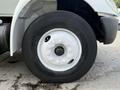 Close-up of a white wheel on a 2008 International 4300 truck showcasing the tire tread and wheel rim details