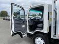 A 2019 Isuzu NRR truck with the driver's side door open revealing the interior with a steering wheel and seating area
