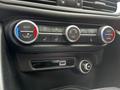 Control panel for climate settings in a 2023 Alfa Romeo Giulia featuring dials for temperature and air conditioning options
