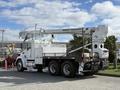 A white 2008 Kenworth T370 with a Terex Telelect aerial work platform mounted on the back and large wheels designed for heavy lifting and utility work