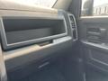 Interior view of a 2015 RAM 1500 showing the dashboard with a storage compartment and controls on the side panel