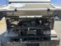 2012 Ford Econoline with the hood raised exposing the engine compartment showcasing various engine components and wiring