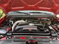 Engine compartment of a 2007 Ford F-550 featuring a turbo diesel Power Stroke V8 engine along with various components and wiring
