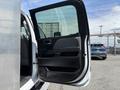 Interior view of a 2020 Chevrolet Silverado with the driver's side door open showing the armrest and controls on the door panel