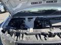2013 Chevrolet Express van with the hood raised displaying the engine compartment and various components visible inside